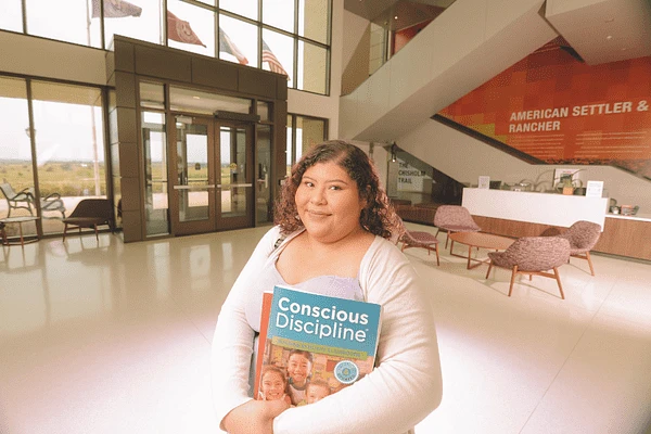 student holding a book